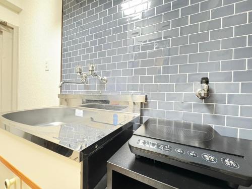 a kitchen with a sink and a counter top at ウィングランデ博多南 in Fukuoka