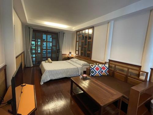 a hotel room with a bed and a table at อัมพวาริเวอร์วิว Amphawa River View in Samut Songkhram