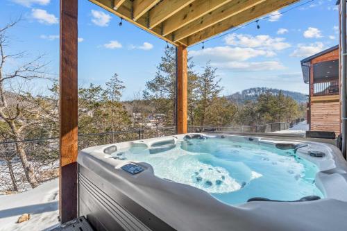 a hot tub on the deck of a house at Timberline Hideaway with Hot Tub in Hollister