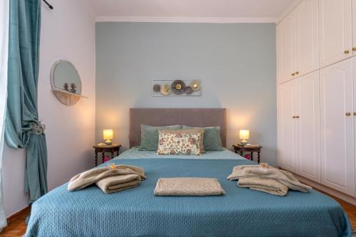 a bedroom with a blue bed with towels on it at Corfu SKYLINE RESIDENT 360 in Corfu