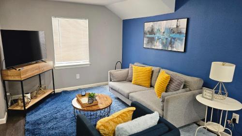 a living room with a couch and a tv at Super Cozy 2 bedroom with Fast WIFI and Queen Bed close to Downtown Houston!! in Houston