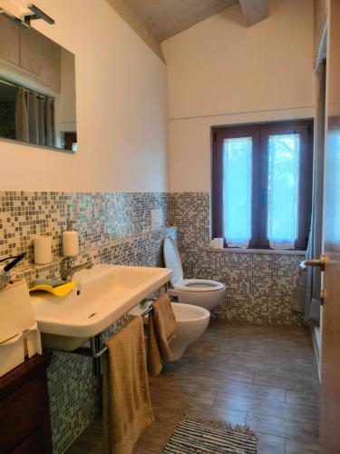 a bathroom with a sink and a toilet at Locazione del cavaliere in Fano