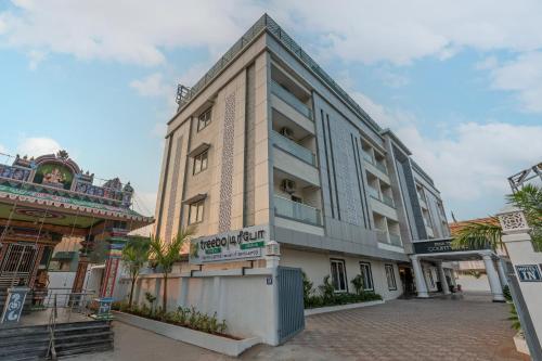 a building with a sign on the side of it at Treebo Premium Pine Tree Courtyard in Chennai