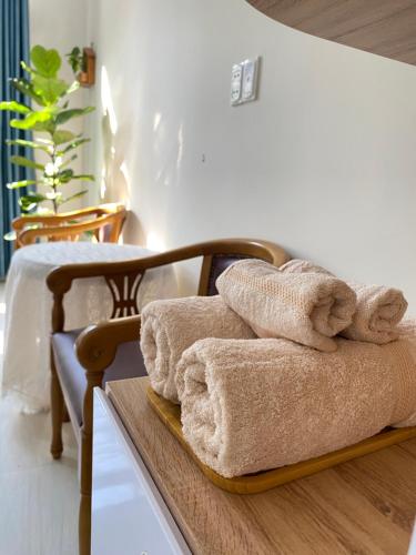 a pile of towels sitting on a table in a room at Jasmine Homestay in Danang