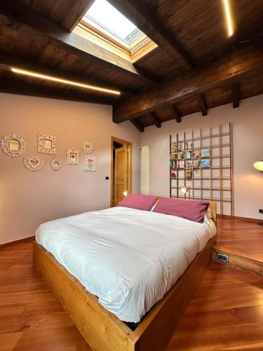 a bedroom with a large bed with white sheets at La cantina dell'artista in Palazzago