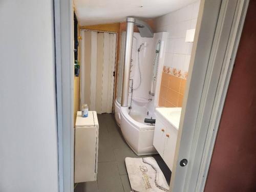 a bathroom with a tub and a toilet and a sink at Welcome to our Mouscron cocoon in Marcinelle