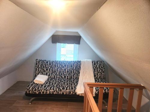 a bedroom with a bed in the attic at Welcome to our Mouscron cocoon in Marcinelle
