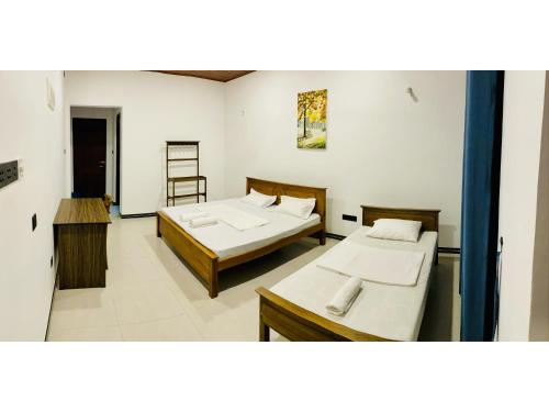 a room with two beds and a ladder in it at Victoria Nature Resort in Digana