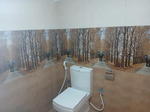 a toilet in the middle of a painting of a forest at Sigiri Arana Sigiriya in Sigiriya