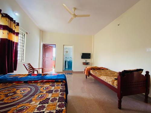 a bedroom with a bed and a ceiling fan at KODAGU MOUNTAIN VIEW Rooms in Madikeri