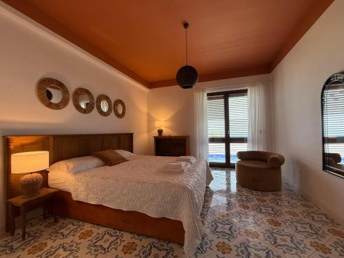 a bedroom with a bed and a chair at Villa BellaVista in Belvedere Marittimo