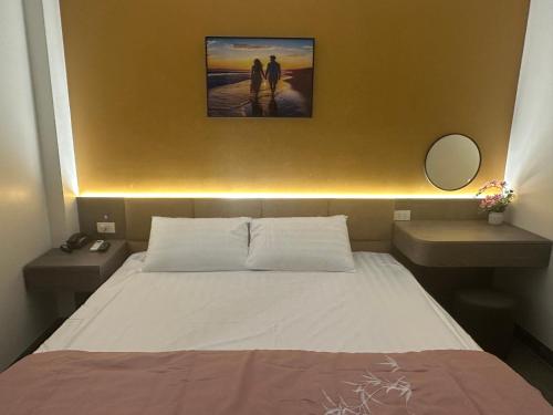 a bedroom with a large bed with two night stands at Ruby Motel in Trà Phương