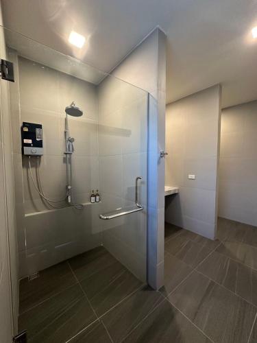 a bathroom with a shower with a glass door at Pearlix Koh Mook in Ko Mook