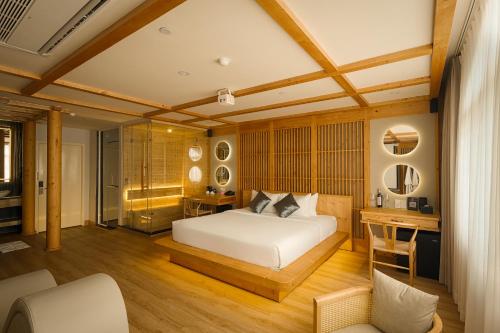 a bedroom with a white bed and a desk and a desk at Cupid Hotel 3 in Ho Chi Minh City