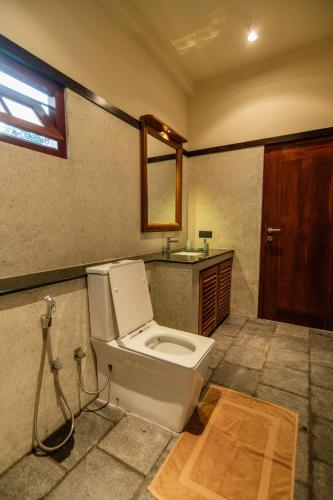 a bathroom with a toilet and a sink at Tropical trails by wija house-unawatuna in Unawatuna