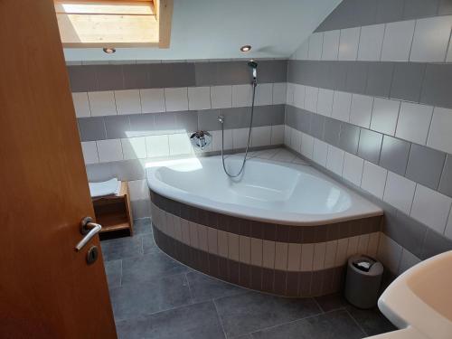 a bath tub in a bathroom with a sink at Haus Luzia in Reith im Alpbachtal