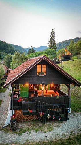 a large house with a roof with a porch at La Răscoala in Petrila