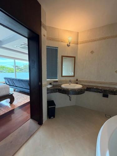 a bathroom with a sink and a mirror at Gooseberry Baan & Bistro in Pattaya South