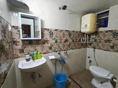a bathroom with a toilet and a sink at Elegant 2 BHK Furnished flat without AC and with AC additional price in Belgaum
