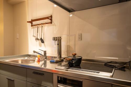 a kitchen with a sink and a counter top at 云溪 表參道 in Tokyo