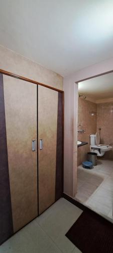 a room with a bathroom with a sliding glass door at Hotel Shri Shanti Niwas in Bikaner