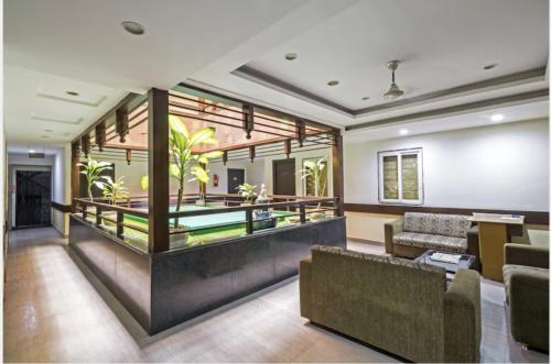 a living room with a couch and a fireplace at Highway Grand Residency in Hyderabad