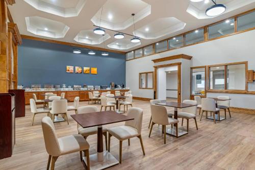a waiting area with tables and chairs in a waiting room at Comfort Inn Pensacola near NAS Corry Station in Pensacola