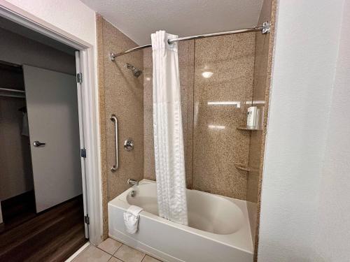 a bathroom with a bath tub and a shower at Country Inn & Suites by Radisson, Athens, GA in Athens