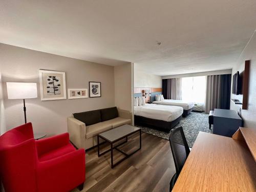 a hotel room with a bed and a living room at Country Inn & Suites by Radisson, Athens, GA in Athens