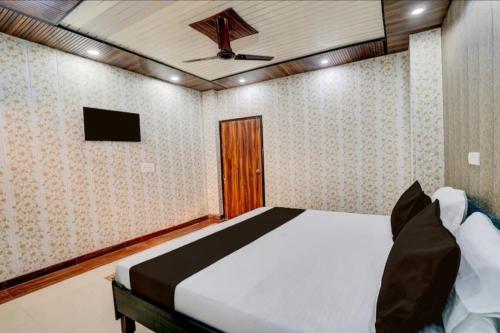 a bedroom with a bed and a tv on the ceiling at Nice hotel in Faridabad