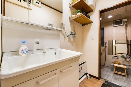 a bathroom with a sink and a shower at New! Ten people Shin Ookubo 6minPocket WIFI in Tokyo