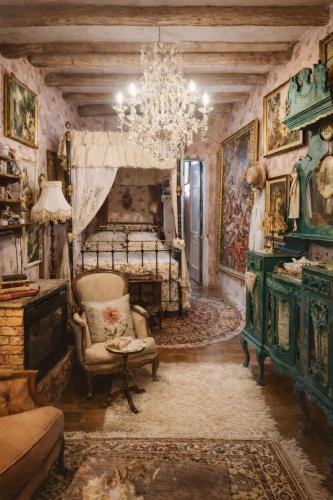a bedroom with a bed and a chair and a chandelier at Tina's Art Home - Venetian Walls District in Nicosia