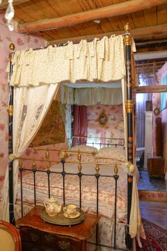a bedroom with a canopy bed with a wooden ceiling at Tina's Art Home - Venetian Walls District in Nicosia