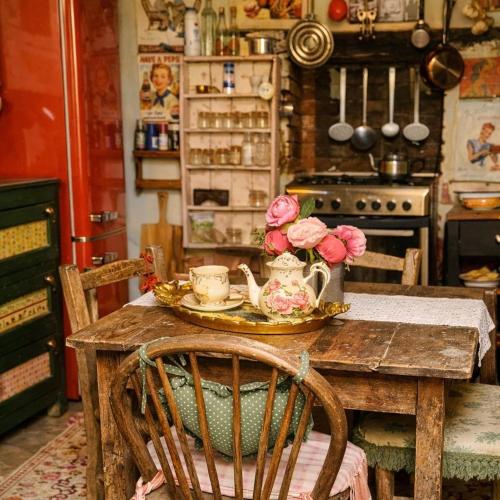 a kitchen with a table with flowers on it at Tina's Art Home - Venetian Walls District in Nicosia