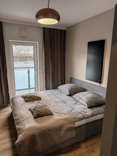 a bedroom with a bed with two pillows on it at Apartamenty TBG Tarnobrzeg in Tarnobrzeg