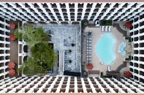 an aerial view of a building with a swimming pool at DoubleTree by Hilton Austin in Austin