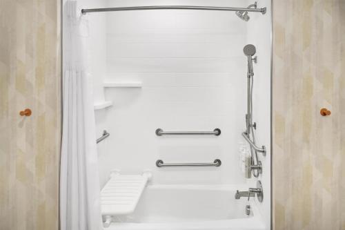 a bathroom with a shower with a toilet at Hampton Inn Midland West in Midland