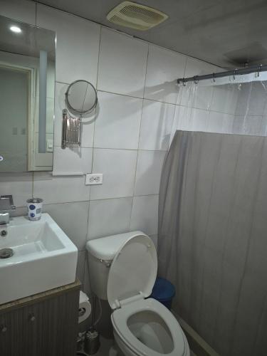 un bagno con un water, un lavandino e uno specchio di Complejo Turístico El Morro a El Morto de Barcelona