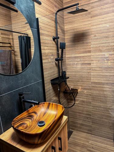 a bathroom with a wooden sink and a mirror at Apartamenty TBG Tarnobrzeg in Tarnobrzeg