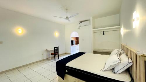 a bedroom with a bed and a desk in it at Oliviana Resort in Bentota