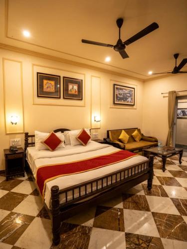 a bedroom with a large bed and a living room at aurum villa's kodiyat in Nāi