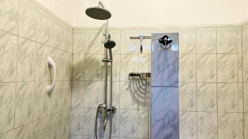 a shower with a glass door in a bathroom at Oliviana Resort in Bentota