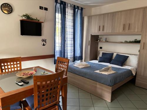 a bedroom with a bed and a table and a dining room at GioIre Home Wellness in Como