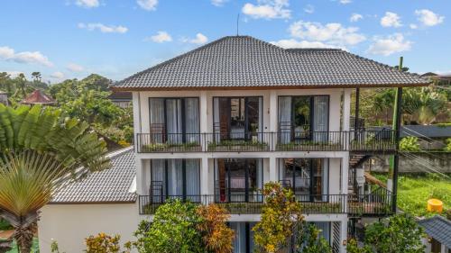 an image of a house with balconies and trees at Palermo Suites by DH in Ubud