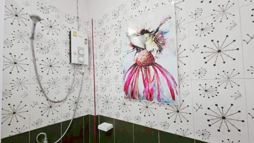 a bathroom with a picture of a bird on the wall at Lake Terrace Resort in Langu