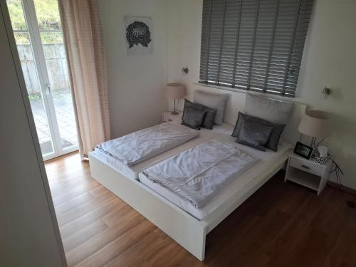 a bedroom with a white bed with two pillows at Jagdschloss Friedrichsthal in Waldeck