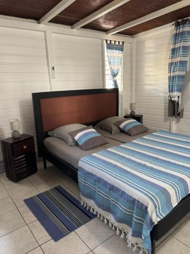a bedroom with a large bed and a window at Ti Kaz in Petit-Bourg