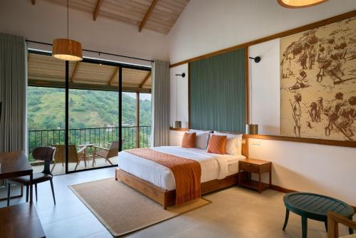 a bedroom with a bed and a large window at Te Dalu Resort & Spa - A Luxury Sanctuary in Ella in Ella