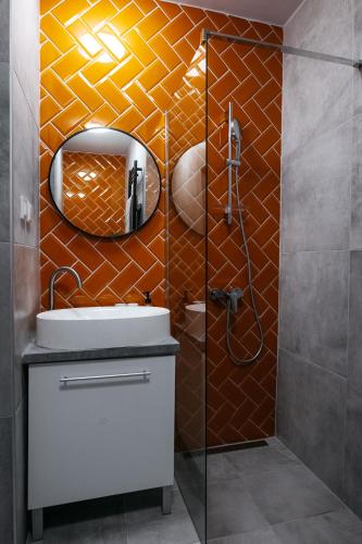 a bathroom with a shower with a sink and a mirror at Wonder Mandragora Mátrafüred in Gyöngyös