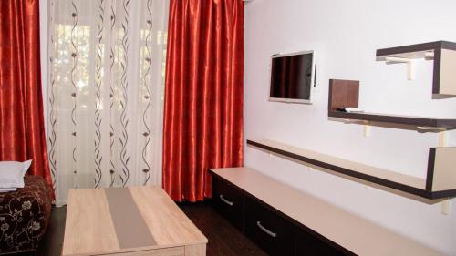 a room with a red curtain and a tv at APARTAMENt ULTRACENTRAL in Tulcea